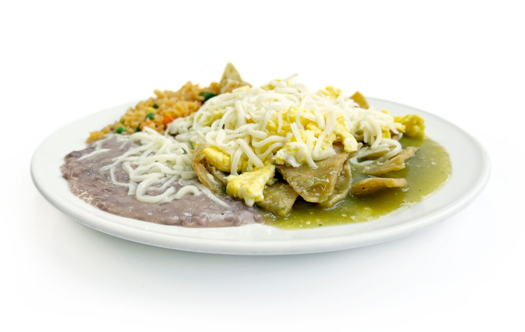 Traditional chilaquiles with salsa verde, cheese, 3 scramble eggs, rice and beans served at Northside Grill Chicago