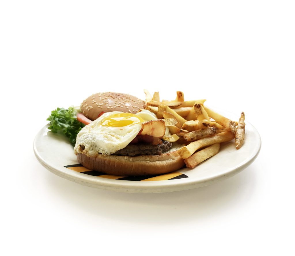 Juicy Chicago burger with lettuce, tomato, cheese, with bacon and one sunny side up on top from Northside Grill