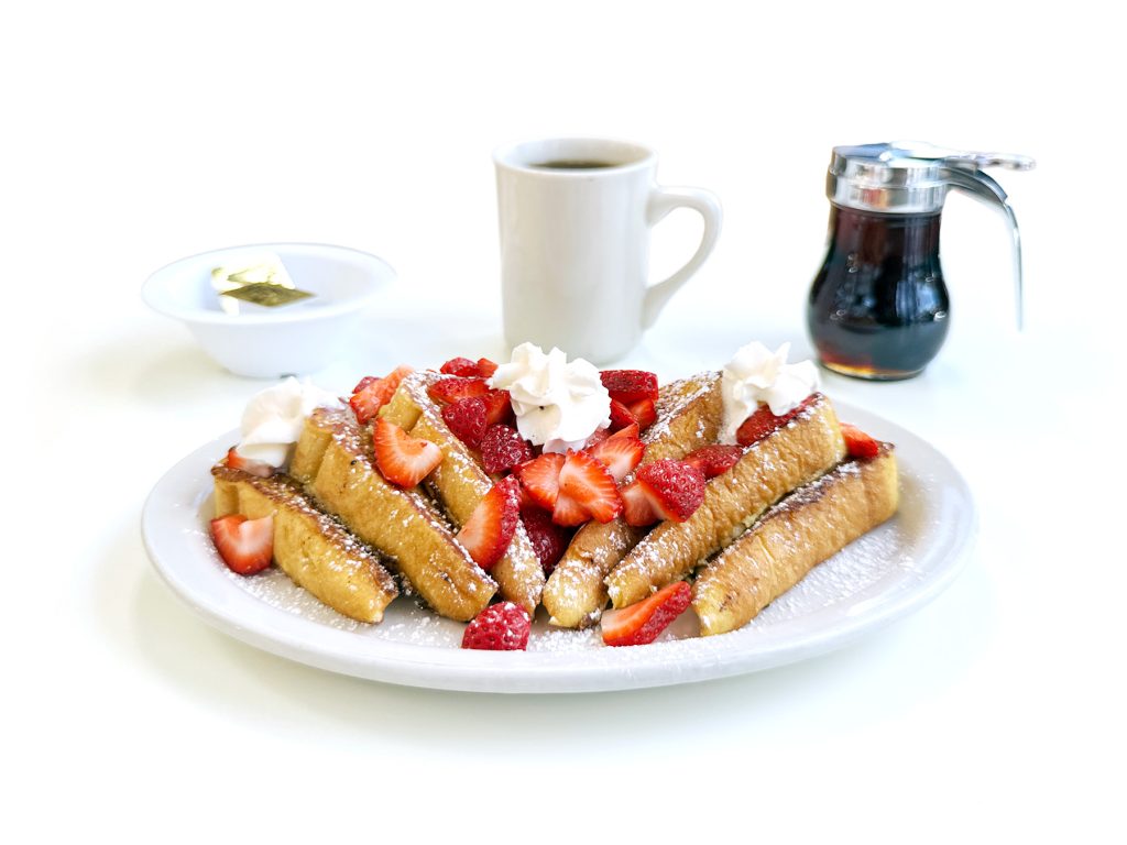 Strawberry French toast topped with fresh strawberries and powdered sugar at Northside Grill in Irving Park Chicago
