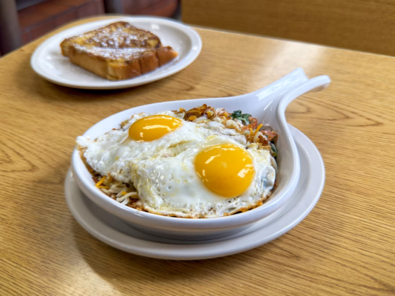 The signature Northside Grill veggie skillet served with a side of thick-cut, powdered sugar-dusted French toast, a perfect Irving Park breakfast combo.